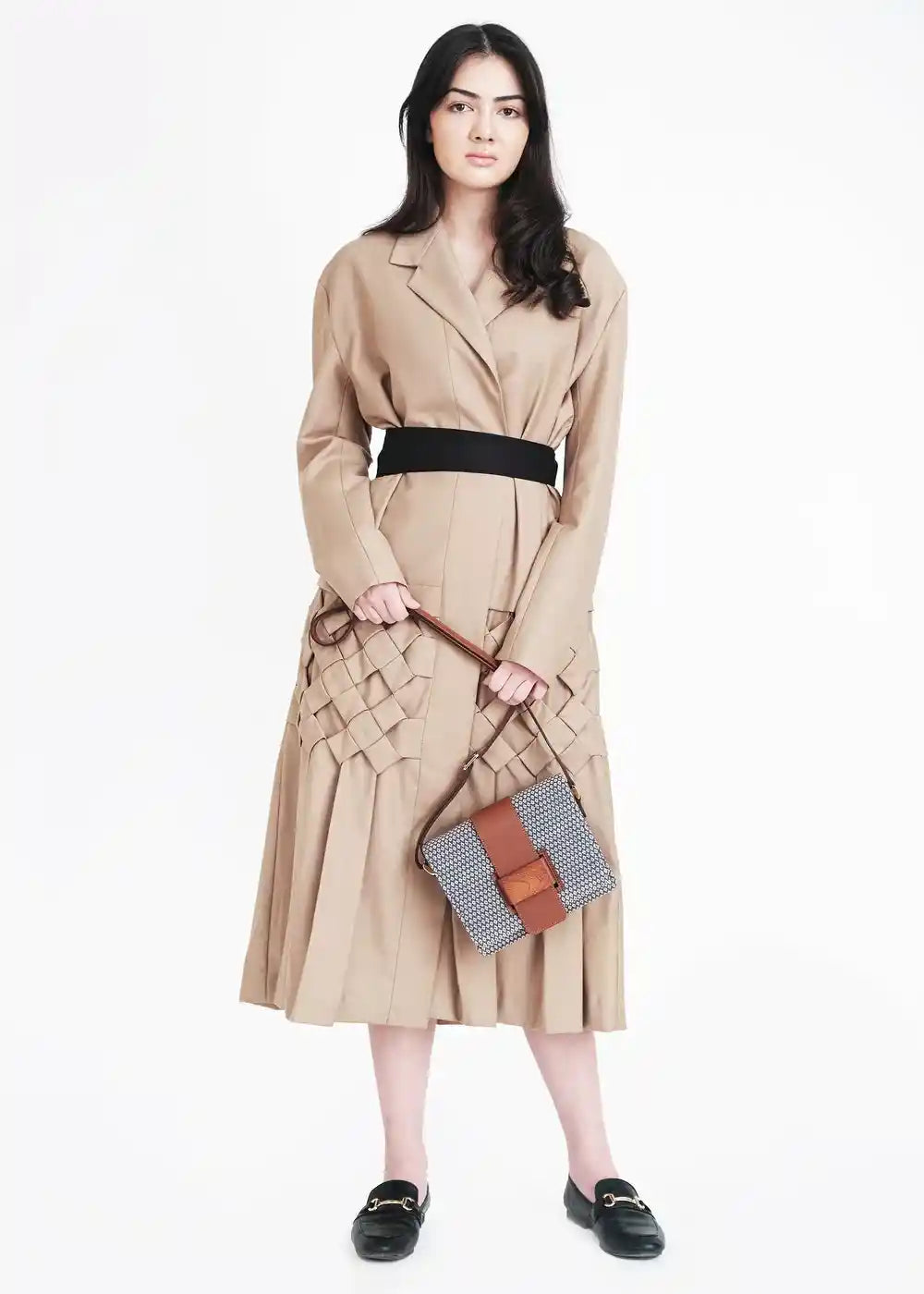 Model carrying Berlin Align Topaz crossbody bag in brown — worn at hip level