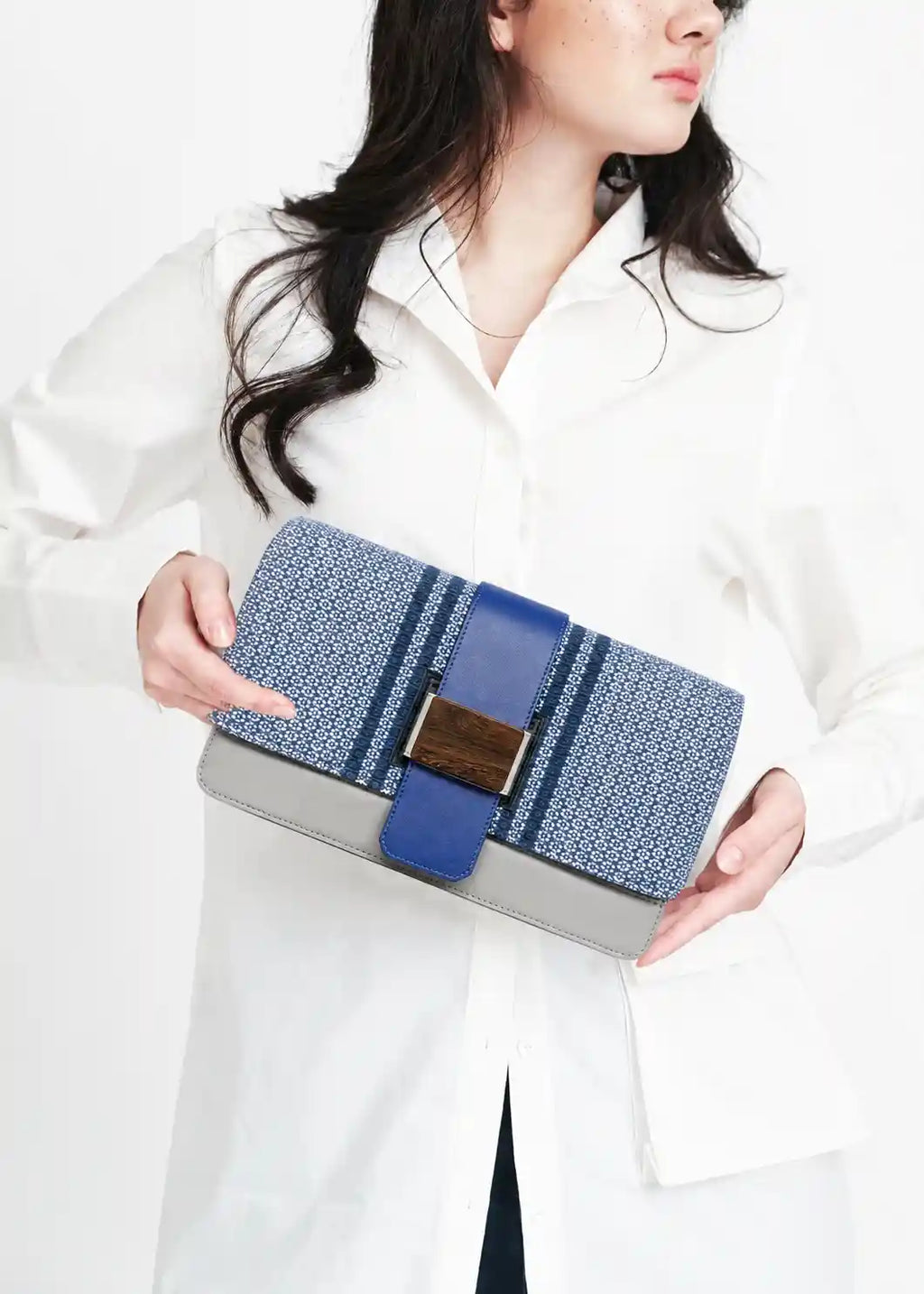 Model holding Berlin Clutch Loop Topaz with multi color nappa leather at special occasion