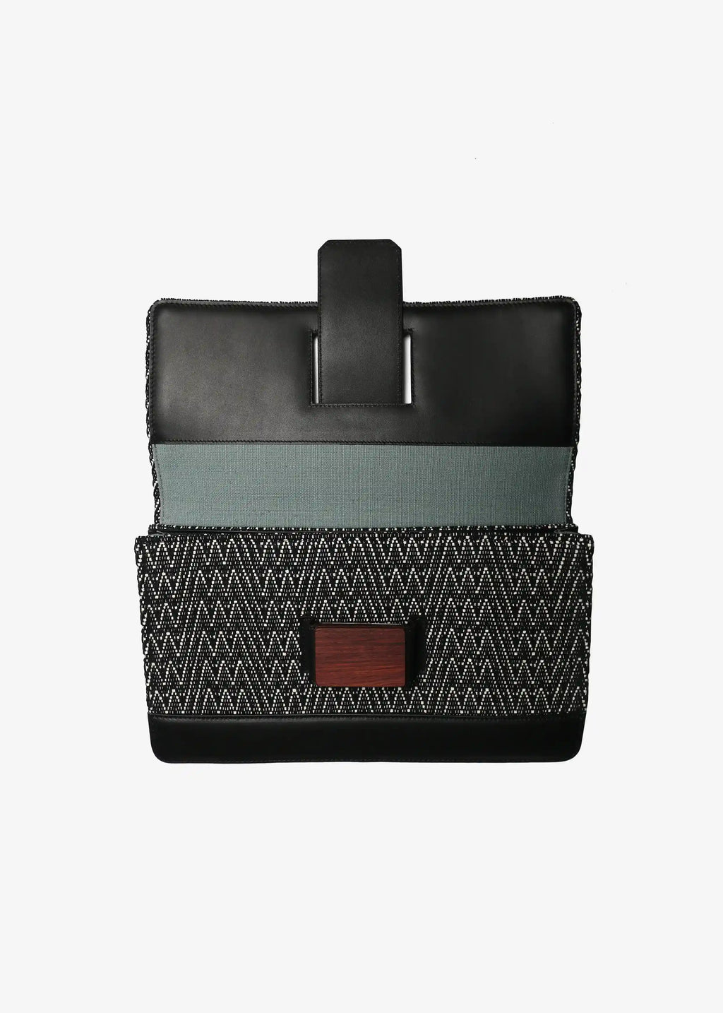 Berlin Clutch Peak Noir interior showing one open pocket and one zipper pocket with fabric lining
