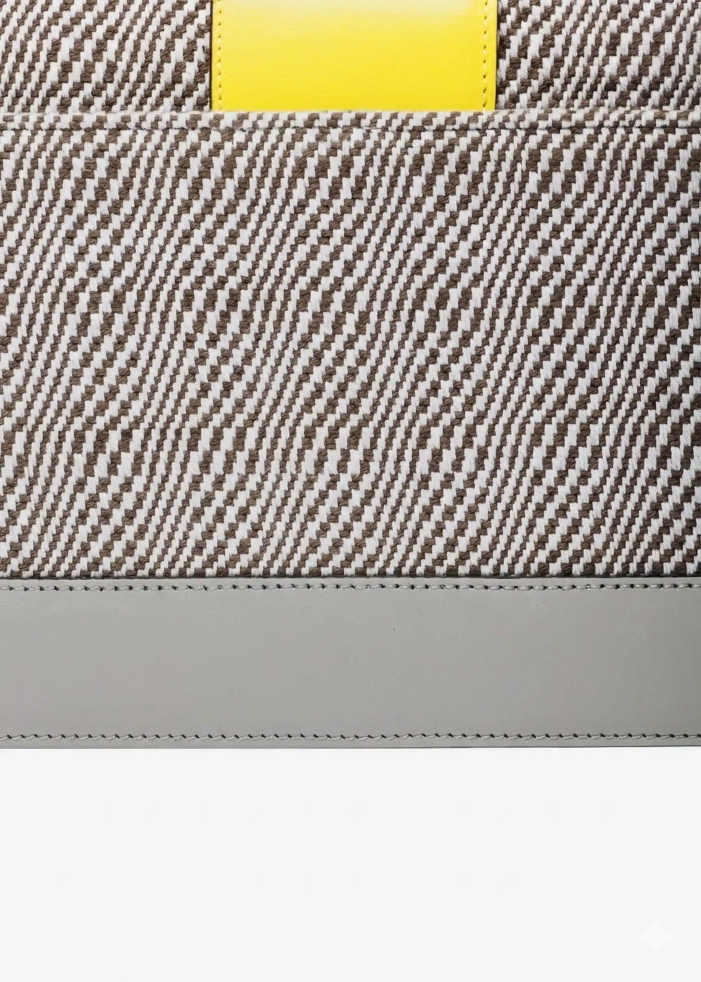 Close-up of Rise Sandstone handwoven cotton weave and multi color leather detail on Berlin Clutch