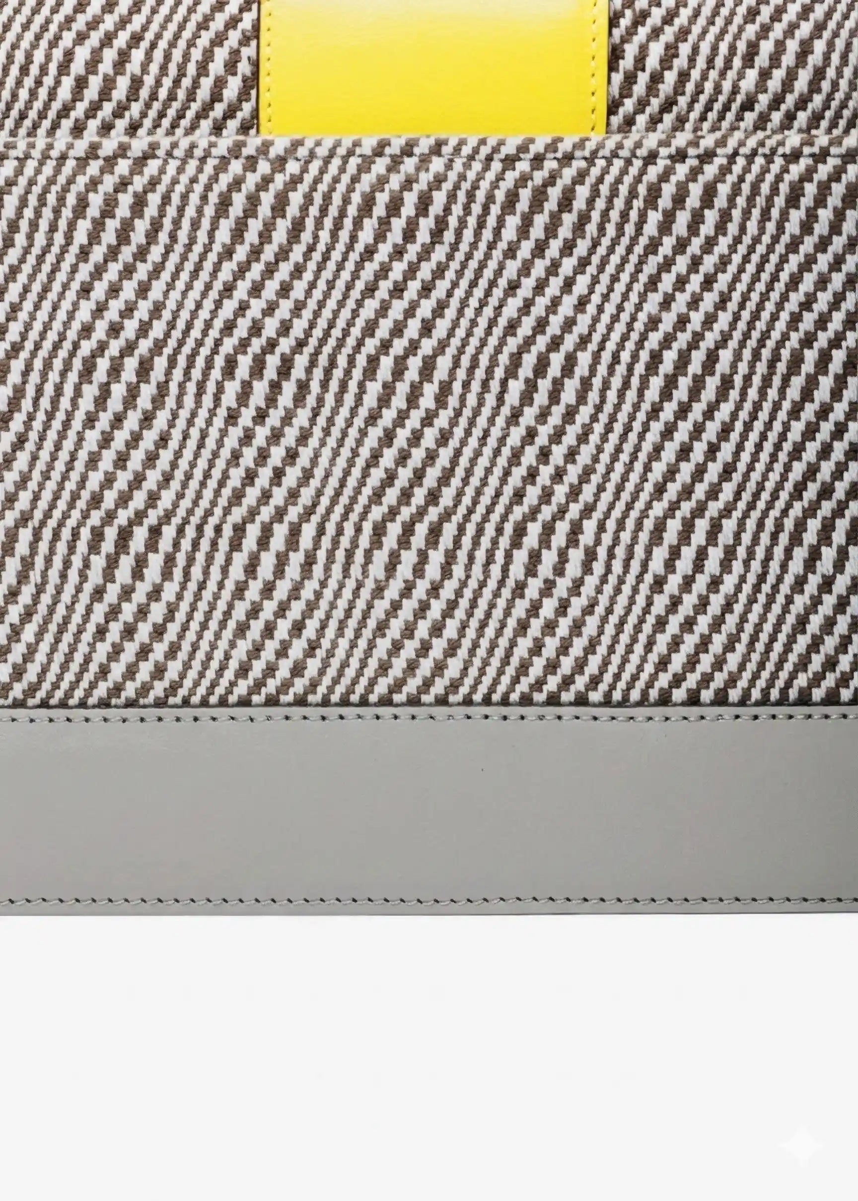 Close-up of Rise Sandstone handwoven cotton weave and multi color leather detail on Berlin Clutch