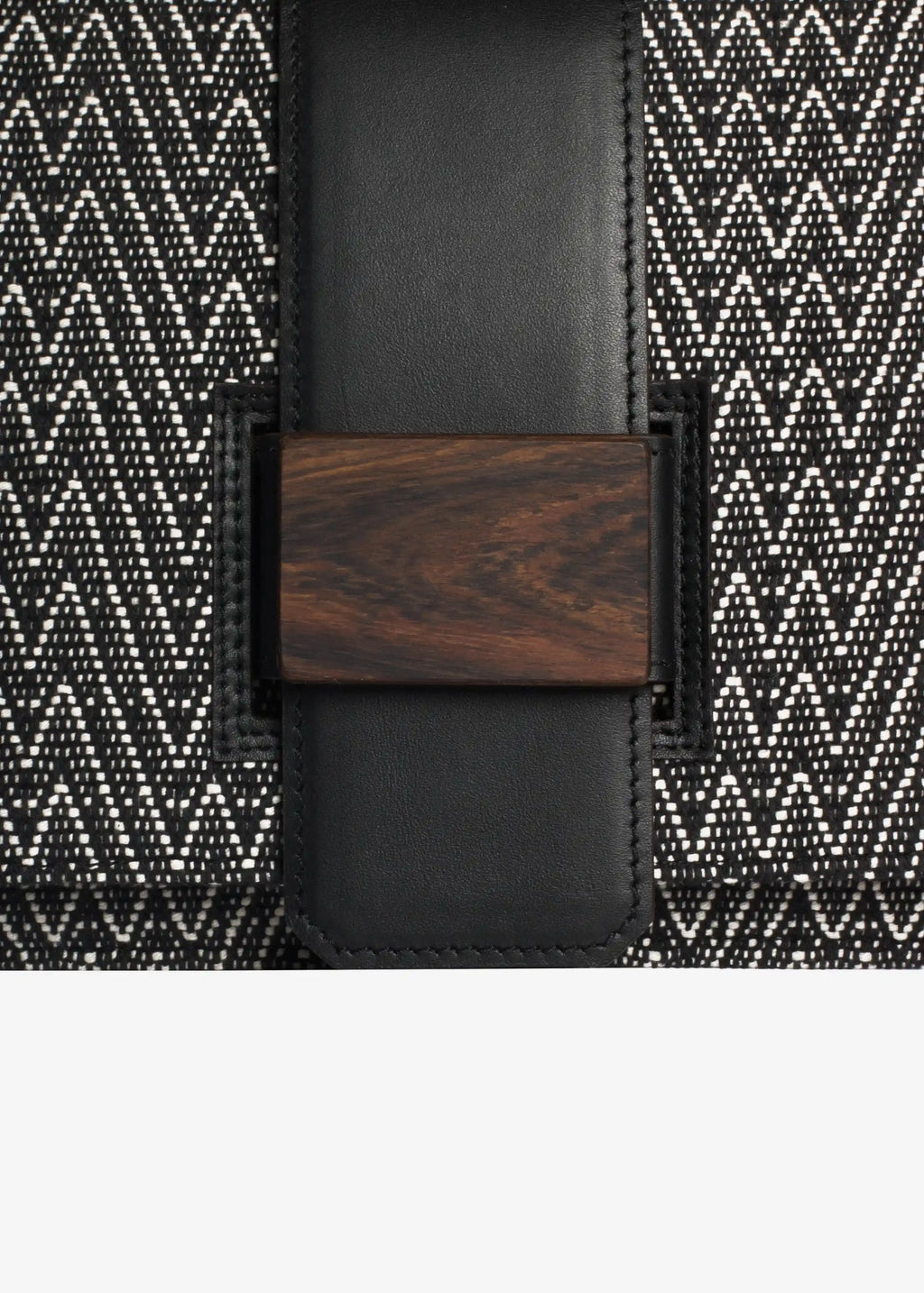 Close-up of reclaimed rosewood buckle and handwoven cotton weave on Berlin crossbody bag