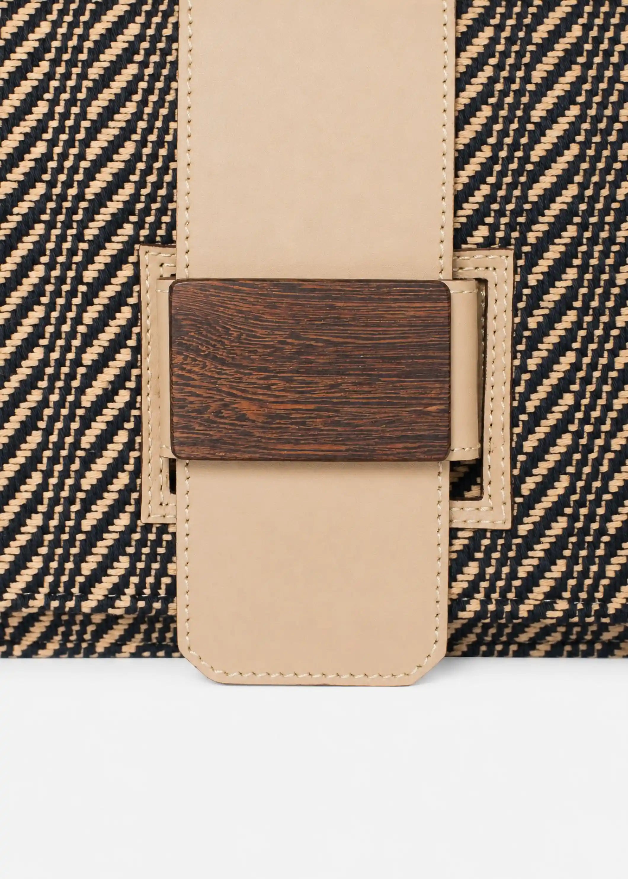 Close-up of reclaimed rosewood buckle and Twist Dusk handwoven cotton weave on Berlin crossbody bag