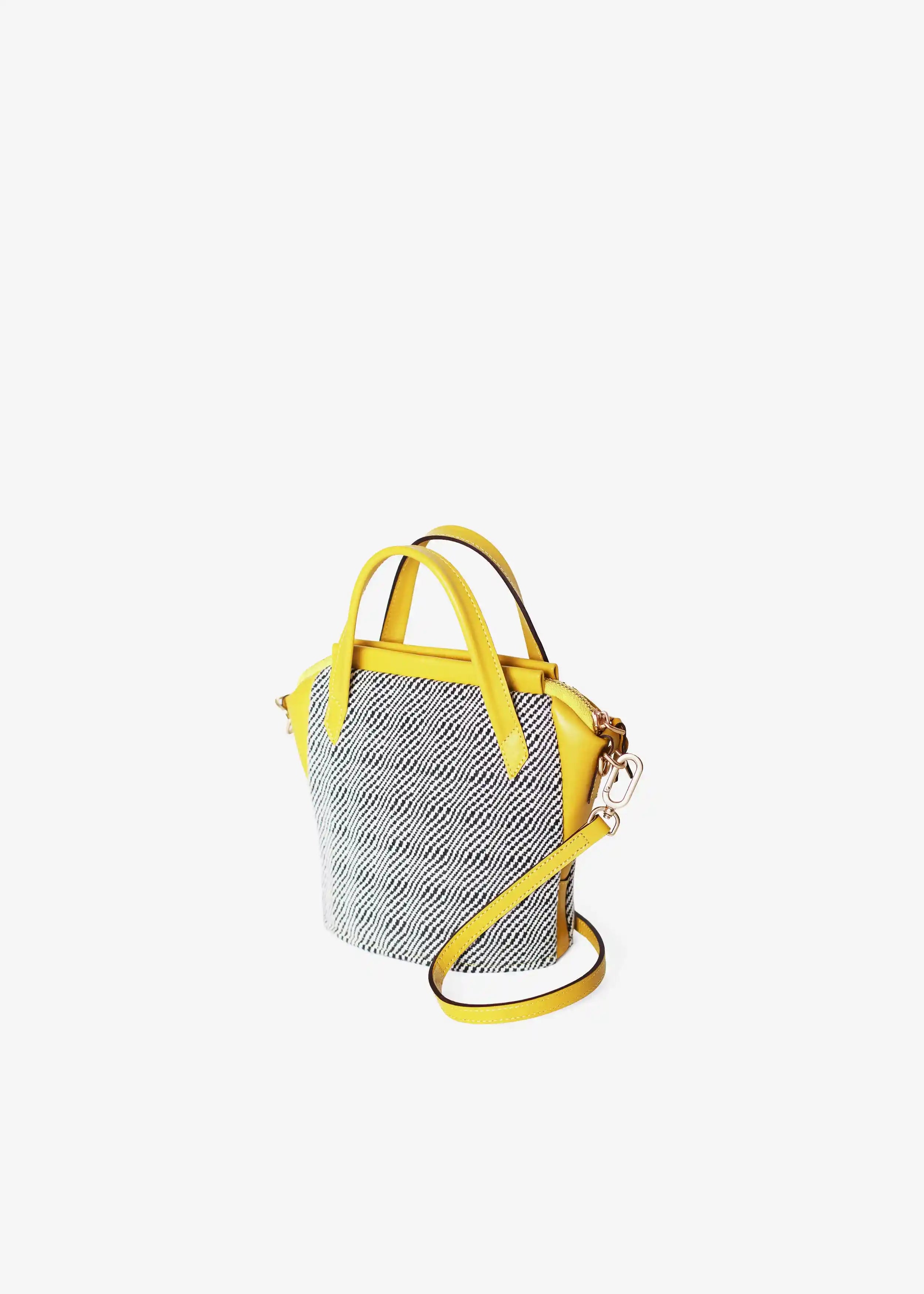 Chicago Mini Rise Salt & Pepper bag perspective view — handwoven cotton with yellow leather double handles and detachable strap