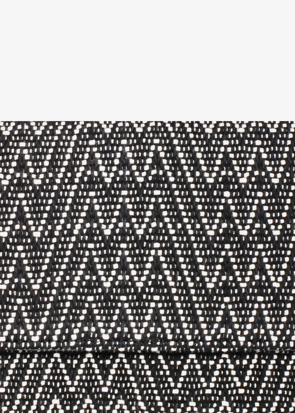 Close-up of Peak Noir handwoven cotton weave on Venice crossbody bag
