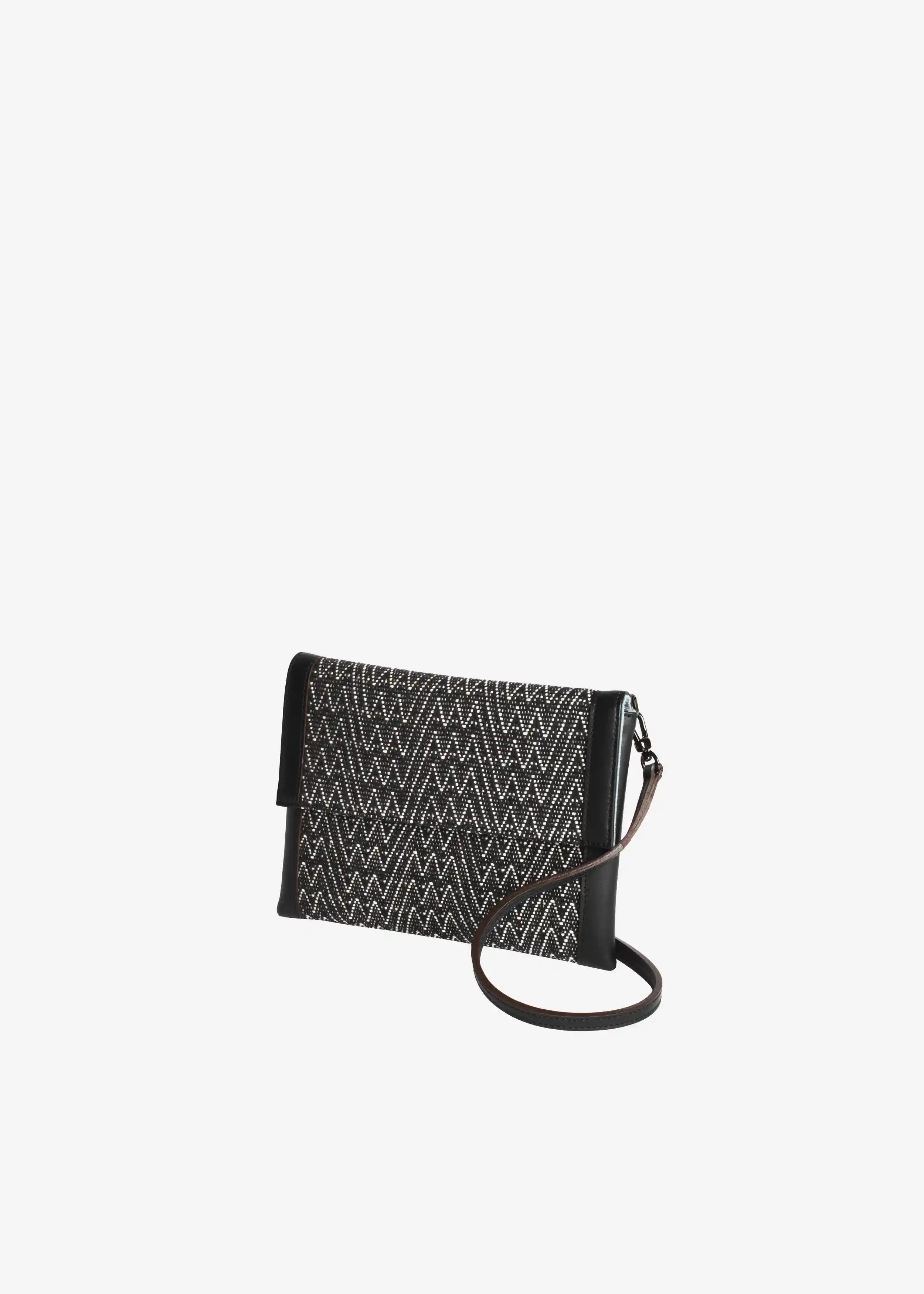 Venice Peak Noir crossbody bag perspective view — handwoven cotton with black nappa leather strap and wrist loop