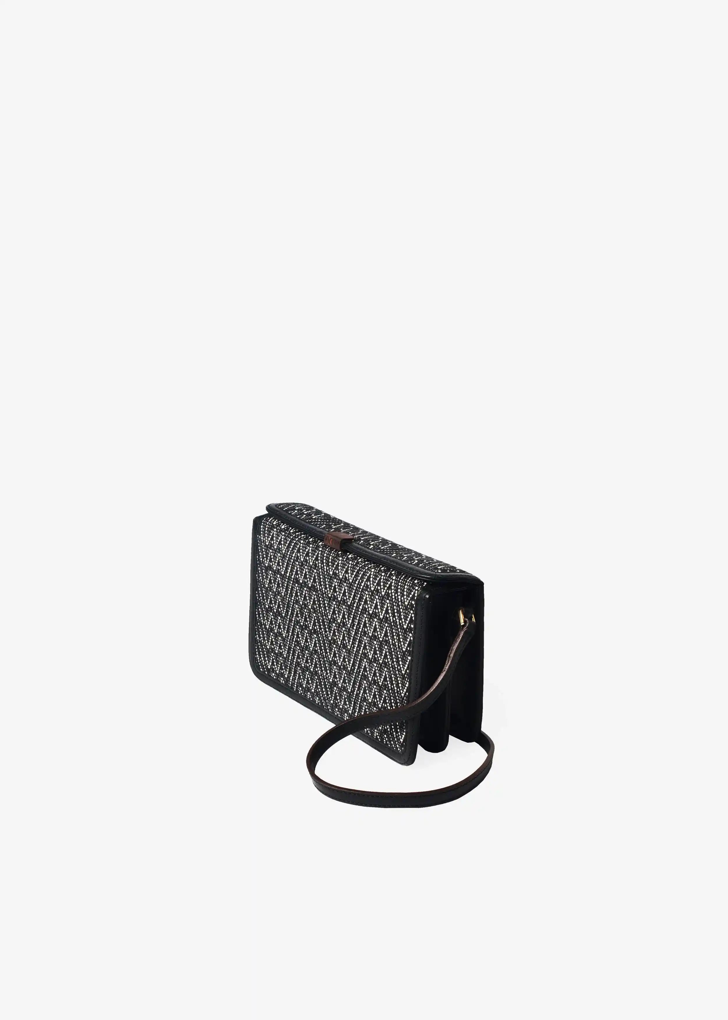 Zürich Peak Noir crossbody bag angled view — compact structured body with black nappa leather and rosewood closure