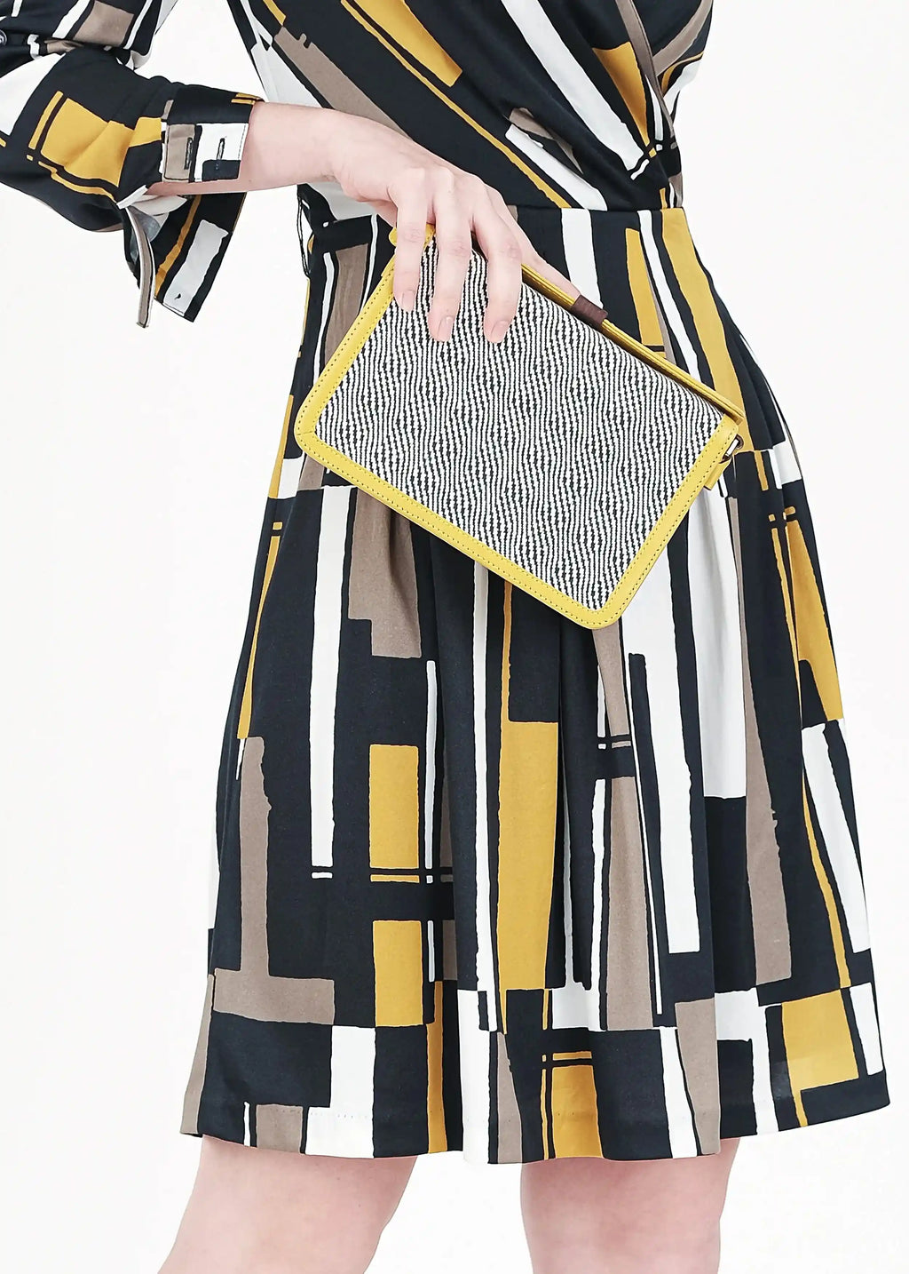 Model holding Zürich Rise Salt & Pepper crossbody bag showing full structured body