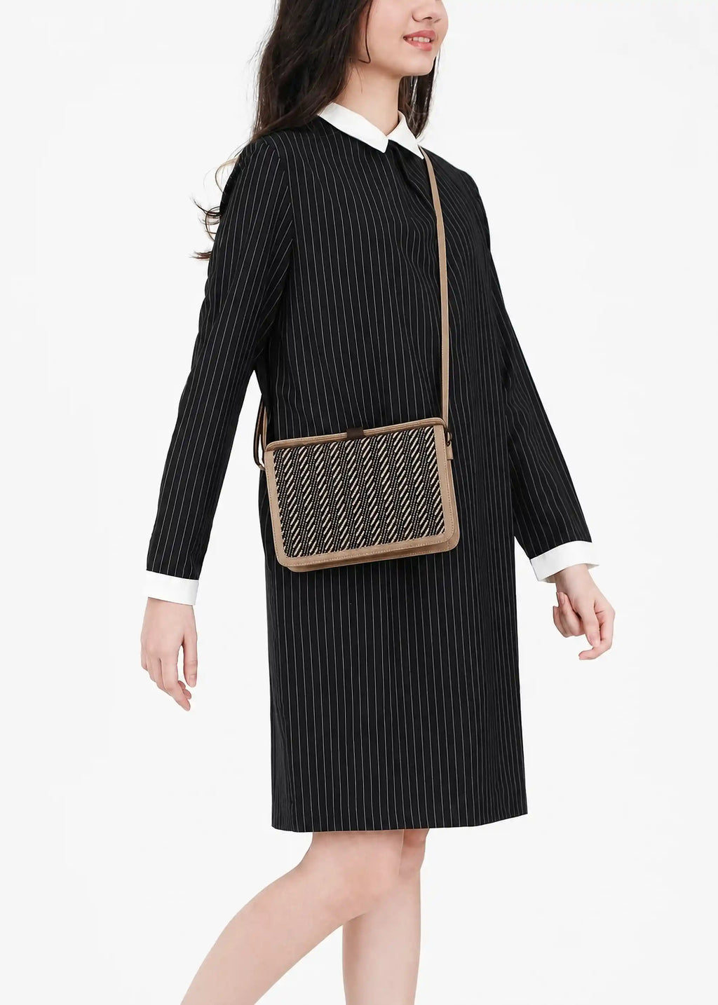 Model holding Zürich Twist Dusk crossbody bag showing full structured body